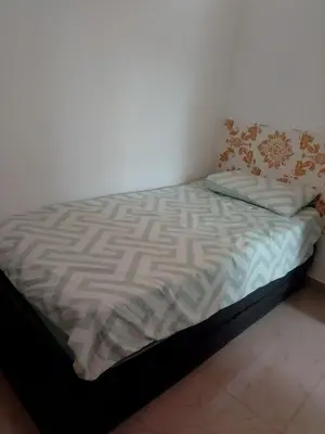 a small bed in a room with at Comodo y acogedor apartamento en Los Mameyes in Los Tres Ojos de Agua