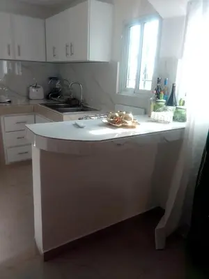 a kitchen with a white island in a kitchen at Comodo y acogedor apartamento en Los Mameyes in Los Tres Ojos de Agua