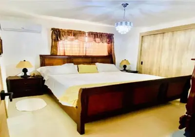 a bedroom with a large bed and two night stands at Hermoso Apartamento de tres habitaciones in La Viva