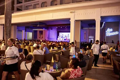 a large crowd of people sitting in a restaurant at Riu Palace Punta Cana - All Inclusive in Punta Cana