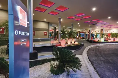 a lobby of a shopping mall with pink lights at Riu Bambu - All Inclusive in Punta Cana