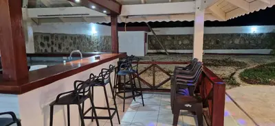 a bar with chairs and a counter in a patio at Casa Perez CCC in Juan Dolio