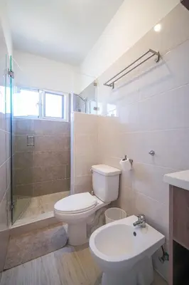 a bathroom with a toilet and a shower and a sink at Le Camere Del Maestro in Bayahibe