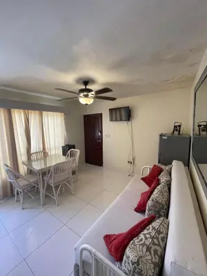 a living room with a couch and a table at Vista palmera in Juan Pedro