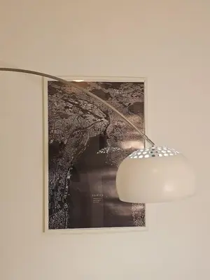 a light hanging on a wall next to a picture at Luxury apartment in Santo Domingo Este in Juan López