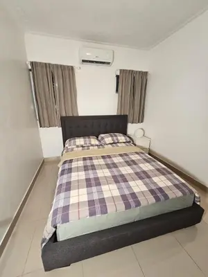 a bedroom with a bed with a checkered blanket at Luxury apartment in Santo Domingo Este in Juan López