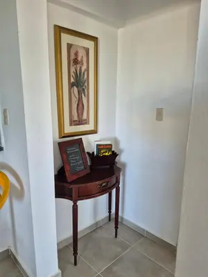 a small table in a room with a picture on the wall at OMY Apartments Nagua 2A in Nagua
