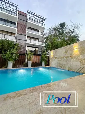 a swimming pool in front of a building at Beachfront apartment Sunset in Colorado