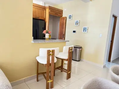 a kitchen with two chairs and a small table at Beachfront apartment Sunset in Colorado