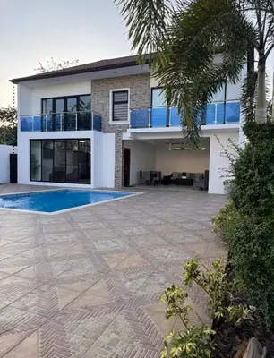 a house with a swimming pool in front of it at villas el guano in Sosúa