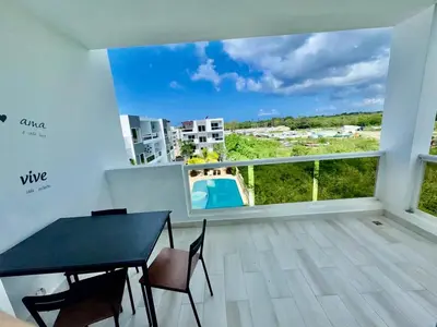 a balcony with a table and chairs and a view at Greta's Penthouse Bayahibe in Bayahibe