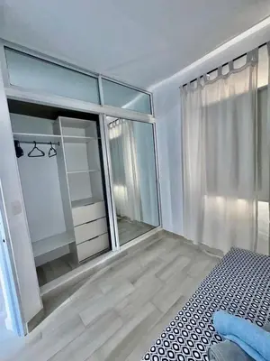 a bedroom with a bed and a large window at Greta's Penthouse Bayahibe in Bayahibe