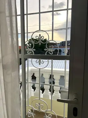 a window with a view of a balcony at Apartamento a solo pasos del centro y la playa in Bayahibe