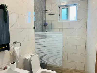 a bathroom with a shower and a toilet and a sink at The Beauty and The Beach in Nagua