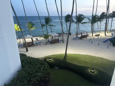 a view of a beach with palm trees and the ocean at Juan Dolio Beach, Marbella Ocean Front in Colorado