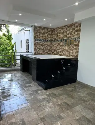 a kitchen with a black counter and a tile floor at Apartamento Oasis in La Caleta