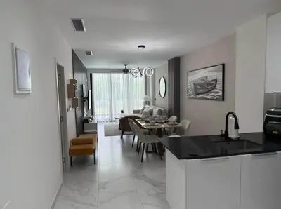 a kitchen and living room with a table and chairs at Escapada Cana Rock con Piscina y Club de Playa in Punta Cana