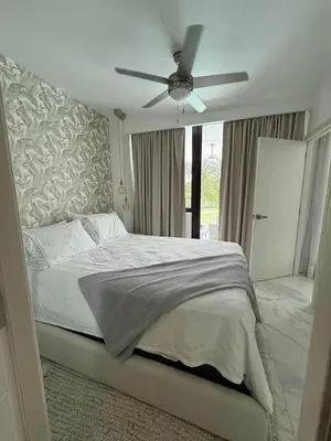 a bedroom with a bed with a ceiling fan at Escapada Cana Rock con Piscina y Club de Playa in Punta Cana