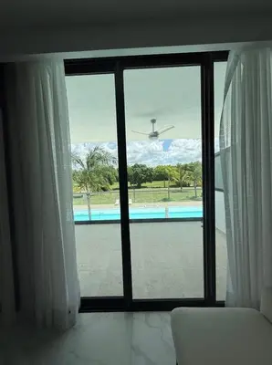 a room with a window with a view of a pool at Escapada Cana Rock con Piscina y Club de Playa in Punta Cana
