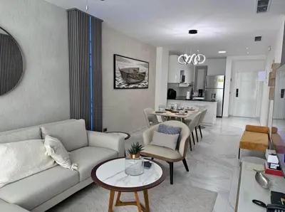 a living room with a couch and a table at Escapada Cana Rock con Piscina y Club de Playa in Punta Cana