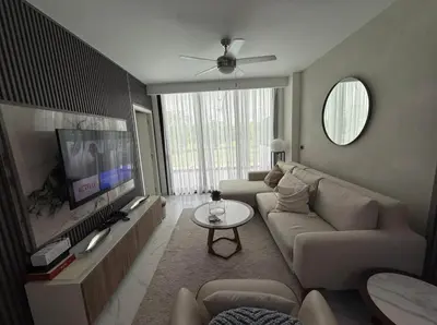 a living room with a couch and a flat screen tv at Escapada Cana Rock con Piscina y Club de Playa in Punta Cana