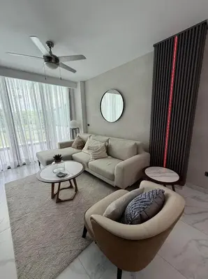 a living room with a couch and a table at Escapada Cana Rock con Piscina y Club de Playa in Punta Cana