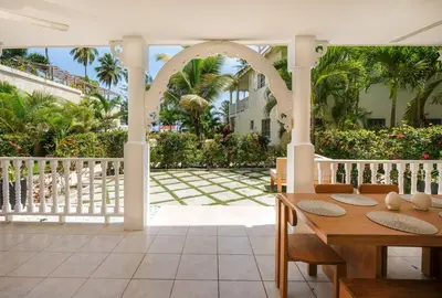 an outdoor patio with a table and chairs at Oceanfront apartment in Las Terrenas
