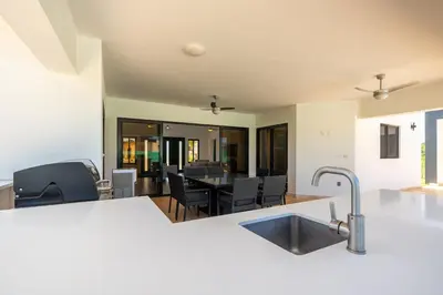 a kitchen and living room with a sink and a table at Location , Vibe , Style in Sosúa