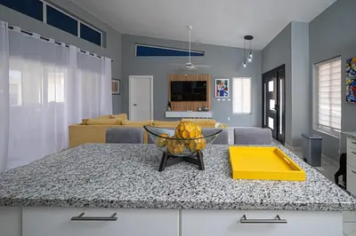 a kitchen with a table with a bowl of fruit on it at Luxury Villa, Garden View and Private Pool in La Mulata