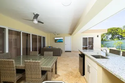 a kitchen and living room with a table and chairs at Luxury Villa, Garden View and Private Pool in La Mulata