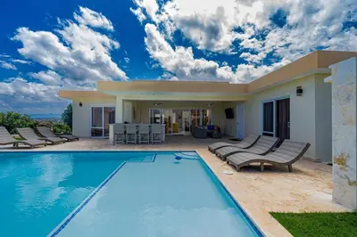 a villa with a swimming pool and a house at Luxury Villa, Garden View and Private Pool in La Mulata