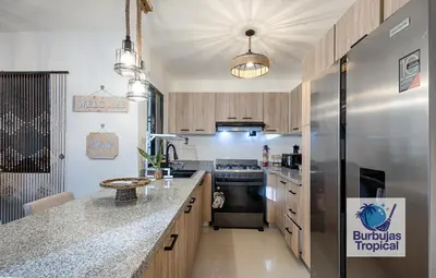 a large kitchen with a stainless steel refrigerator at 3 Bdr Apt in La Romana - Full Kitchen - Pool - Gym - Security in Cumayasa Kilómetros Diez