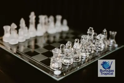 a chess board with glass chess pieces on it at 3 Bdr Apt in La Romana - Full Kitchen - Pool - Gym - Security in Cumayasa Kilómetros Diez