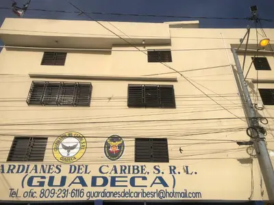 a white building with a sign on the side of it at Apartamento de lujo amueblado Guadeca B in Juan López