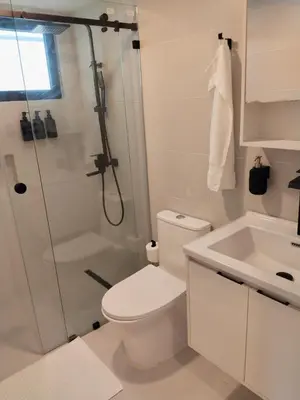 a bathroom with a shower and a toilet and a sink at Prado Suites Las Terrenas in Las Terrenas