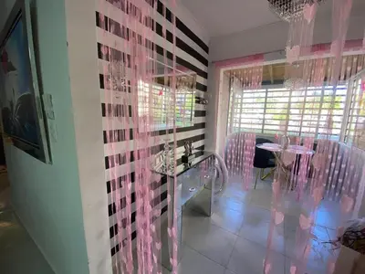 a dining room with pink and black walls and a table at Prados de la Montana in Bartola