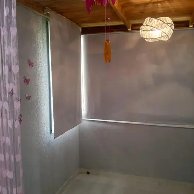 a corner of a room with a window and a curtain at Prados de la Montana in Bartola