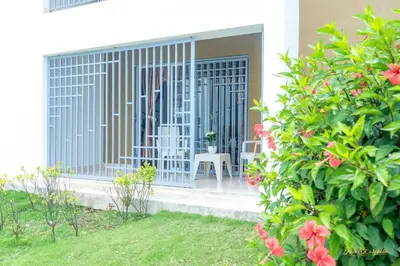 a gate to a house with chairs and flowers at Next to Basilica 3BR terrace wifi Punta Cana 30min in Higuey