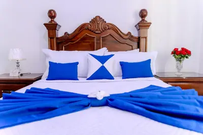 a bed with a blue bow on it at Next to Basilica 3BR terrace wifi Punta Cana 30min in Higuey