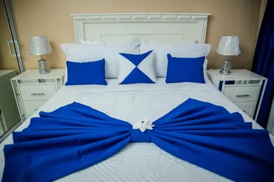 a bed with a blue bow on it at Next to Basilica 3BR terrace wifi Punta Cana 30min in Higuey