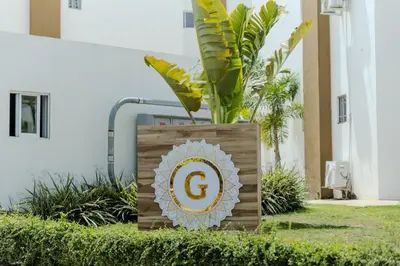 a sign with the g on it in the grass at Next to Basilica 3BR terrace wifi Punta Cana 30min in Higuey
