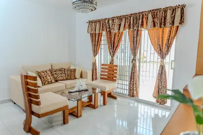a living room with a couch and a table at Next to Basilica 3BR terrace wifi Punta Cana 30min in Higuey