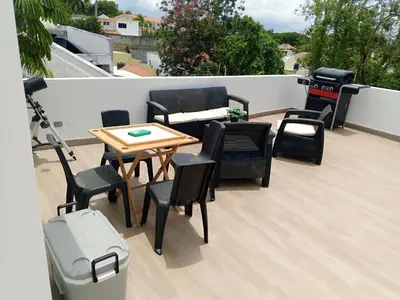 a patio with chairs and a table on a roof at Casahermosa in Santo Domingo