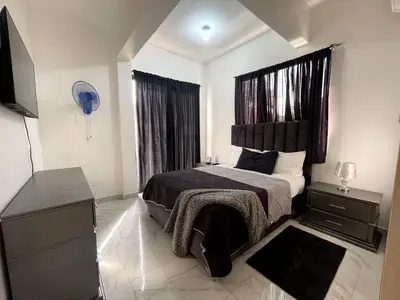 a bedroom with a bed with a black headboard at Casahermosa in Santo Domingo