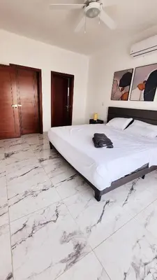 a bedroom with a large bed with marble floors at Villa in SOV, close to Santa Fe in Sosúa