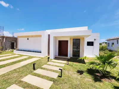 a white house with a pathway in front of it at Villa in SOV, close to Santa Fe in Sosúa