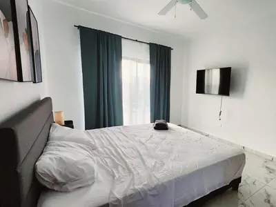 a bedroom with a bed and a window at Villa in SOV, close to Santa Fe in Sosúa