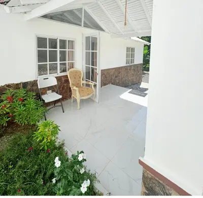 a patio with two chairs and a table at Colina Buena Vista VIP in Jarabacoa