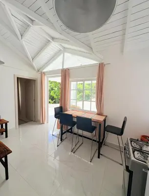 a dining room with a table and chairs at Colina Buena Vista VIP in Jarabacoa