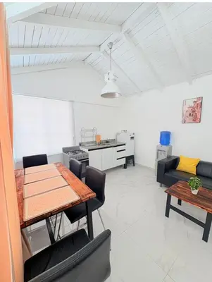 a living room with a table and a couch at Colina Buena Vista VIP in Jarabacoa